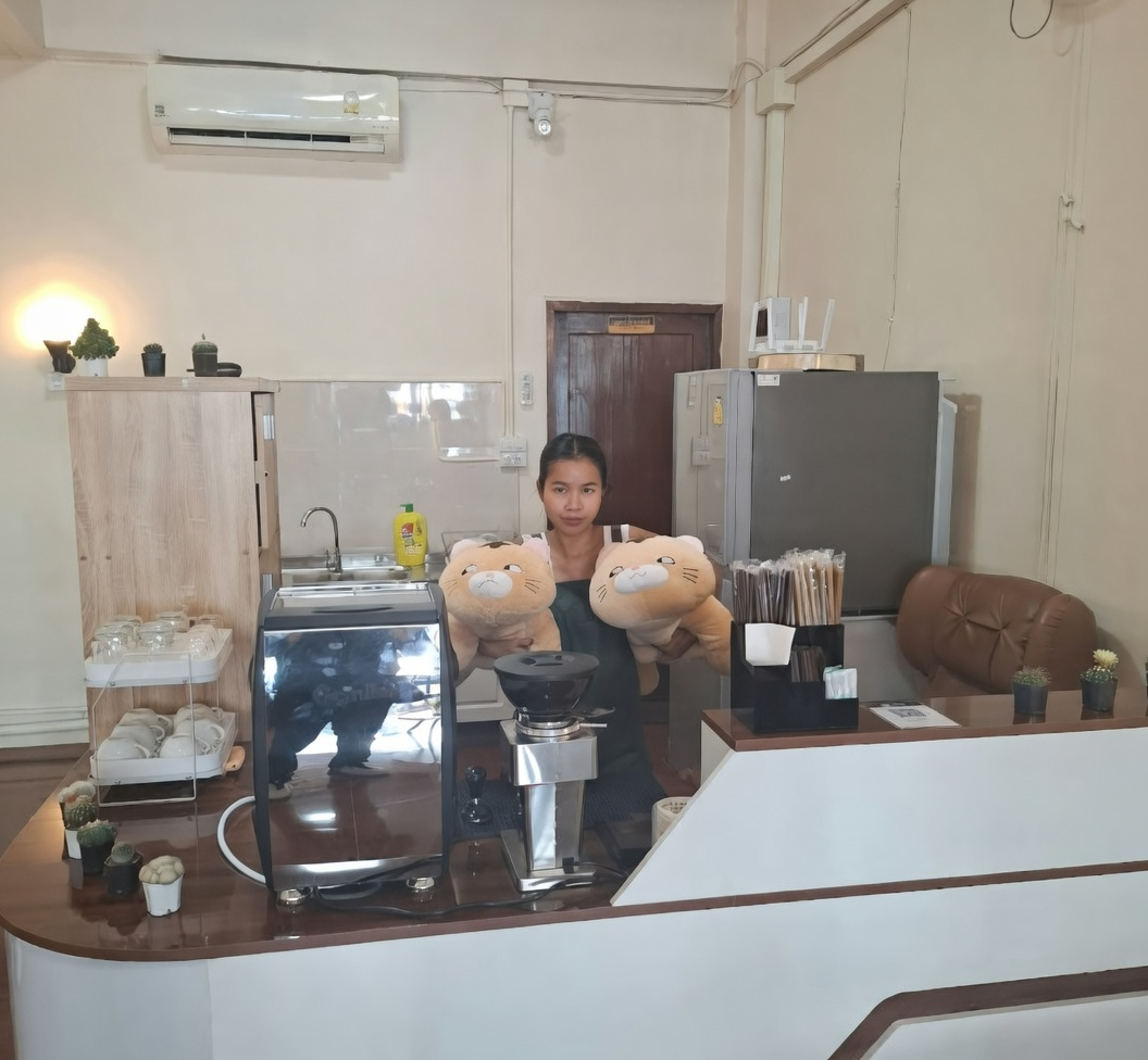 Owner of Greek Yogurt and Protein at the counter with cups and plants