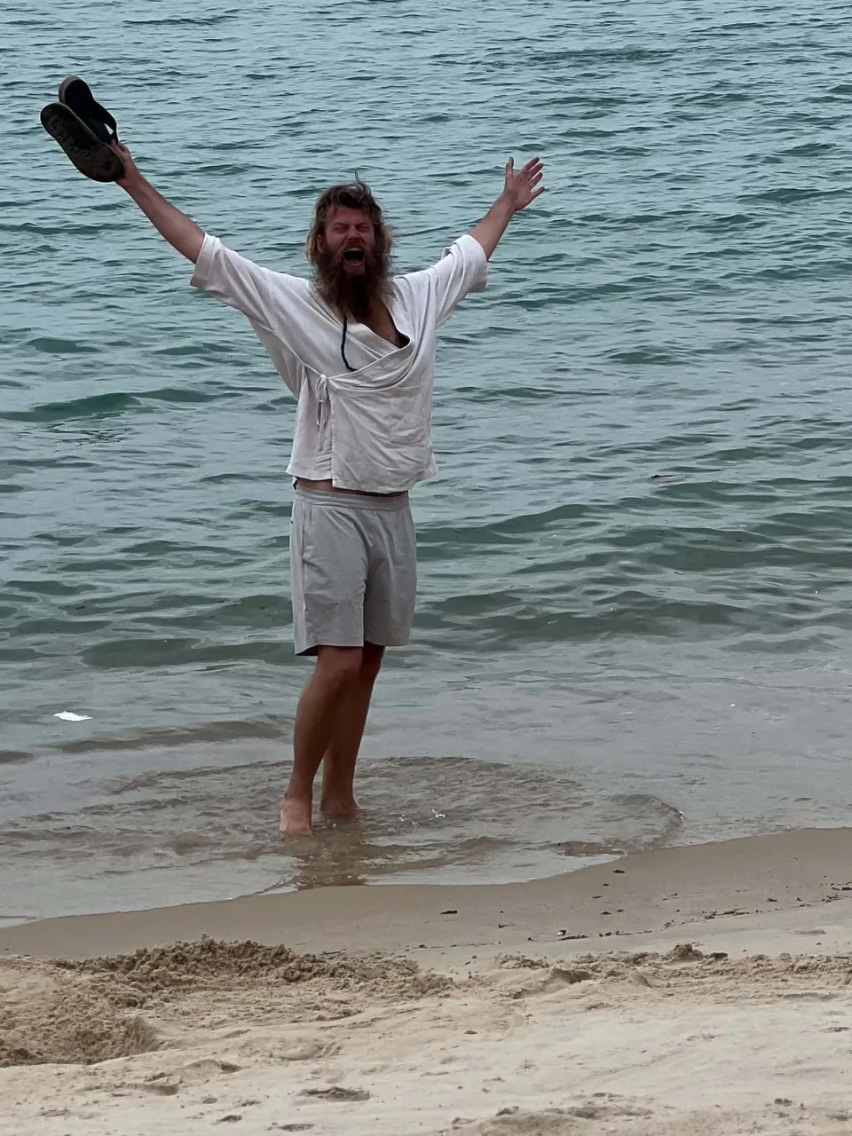 Rick in the sea, arms up